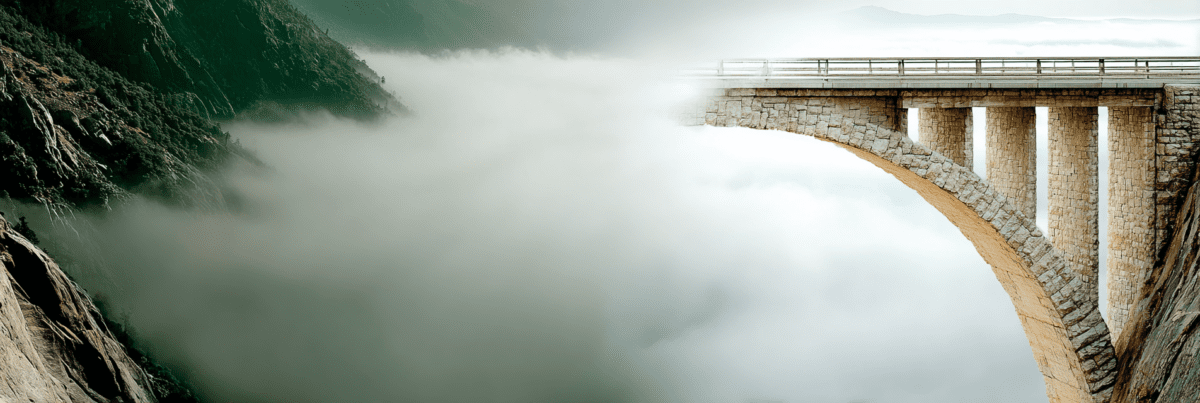 A minimalist wide shot of a slender stone arch bridge stretching across a steep mountain canyon filled with thick, white mist. The bridge appears to float in the clouds, representing the quiet suspension of a transition.