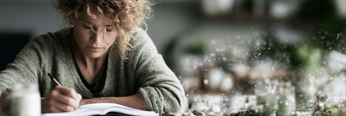 A person writes in a notebook at a table while abstract digital fragments blur into the background, suggesting the subtle and often unnoticed influence of technology on thinking, learning, and daily activitie